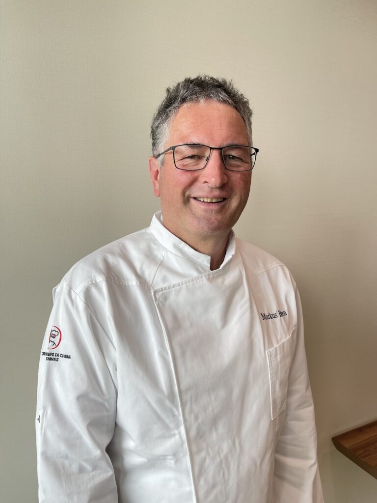 a man in a white chef's coat